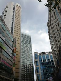 Low angle view of modern buildings in city against sky