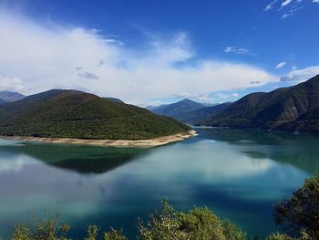 Scenic view of lake and mountains against sky