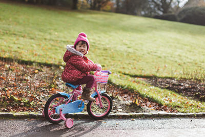 Portrait of girl riding bicycle on road