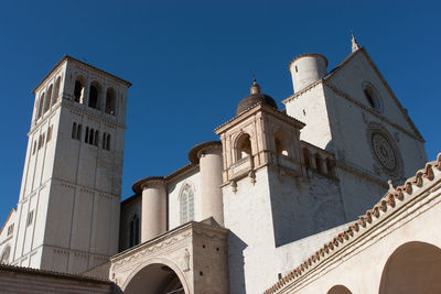 Low angle view of bell tower against blue sky