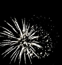 Low angle view of firework display at night