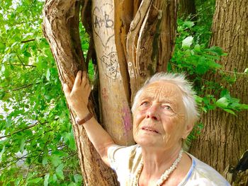 Woman sitting on tree trunk