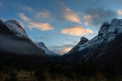 Scenic view of mountains against cloudy sky