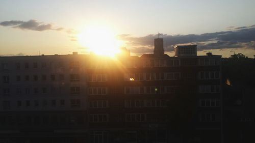 Buildings in city at sunset