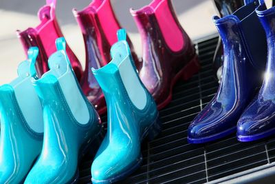 Close-up of multi colored shiny shoes on metal grate