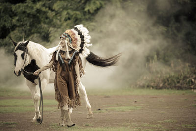 Horse running on field