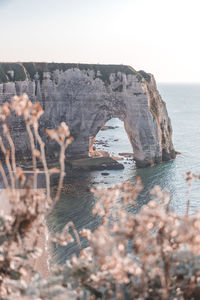 Rock formations by sea against sky