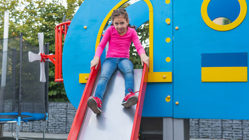 Low angle view of girl standing on playground