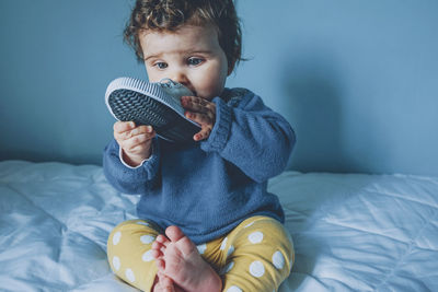 Cute baby girl on bed at home