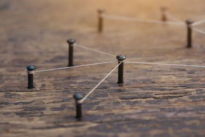 Close-up of old metal on table against wall