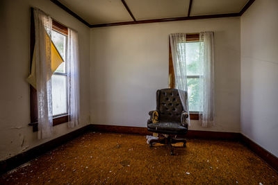 Empty chair in abandoned home