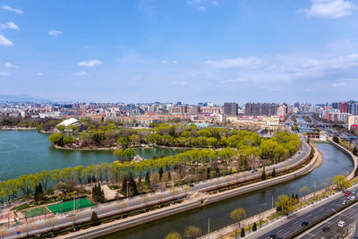 High angle view of river amidst buildings in city against sky