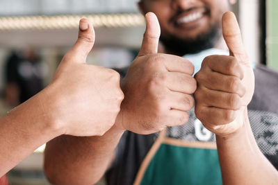 Close-up of hands gesturing thumbs up