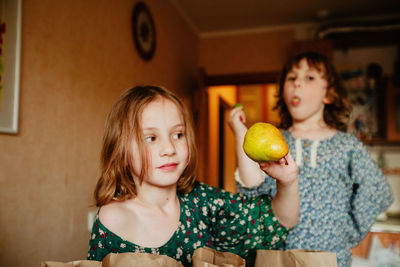 Portrait of smiling girl holding fruits