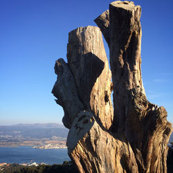 Rock formation on mountain against blue sky