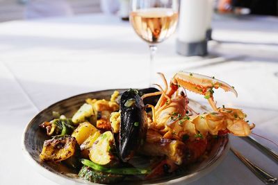 Close-up of paella served in plate on table in restaurant