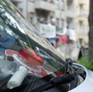 Close-up of car on road