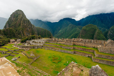 Scenic view of mountains against cloudy sky