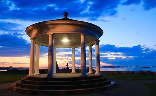 Low angle view of water tower against sky during sunset