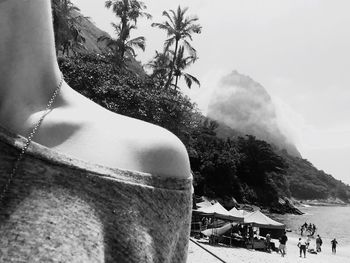 Close-up of woman at beach against sky