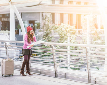 Woman standing by railing