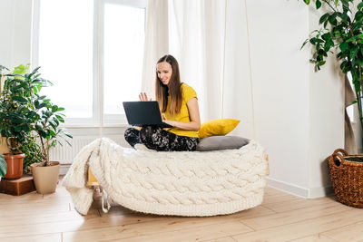 Woman sitting on chair at home