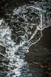 High angle view of water flowing through rocks