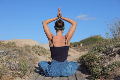 Rear view of woman practicing yoga