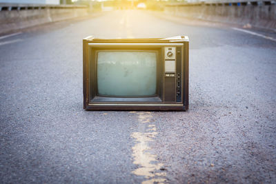 Close-up of old television set on road