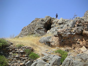 Rock formations on landscape against blue sky