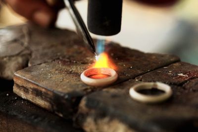 Fire heating metallic ring in workshop