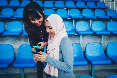 Full length of young woman using mobile phone