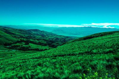 Scenic view of mountains against blue sky