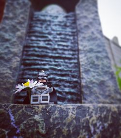 Low angle view of cross on rock