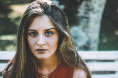 Close-up portrait of young woman at park