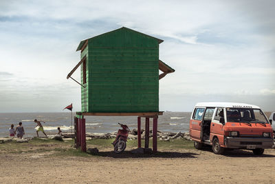 People on beach against sky