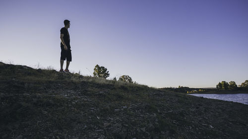 Man standing on field against sky