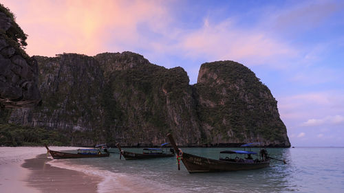 Boats moored on sea against sky