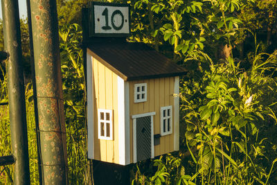 Exterior of house against trees and plants