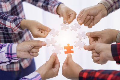 Midsection of man holding jigsaw puzzle