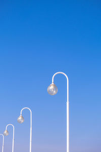 Street lights at daytime on blue sky background. creative abstract pattern photo. round street lamps