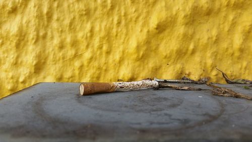 Close-up of cigarette on wood