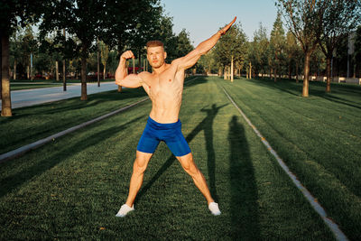 Low section of man exercising on field