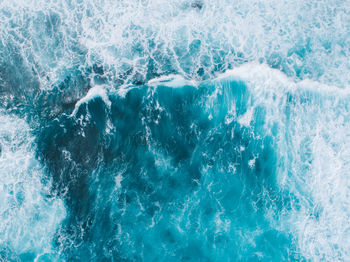 Aerial view of waves of blue sea water 