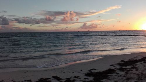 Scenic view of beach against sky during sunset