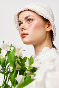 Portrait of young woman with flowers
