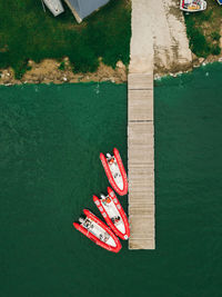 Red inflatable boats stand near the pier.aerial view by drone.