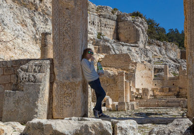 Woman standing by old ruins