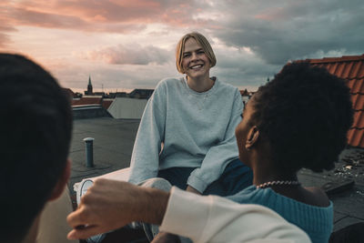 Portrait of a smiling young woman against sky