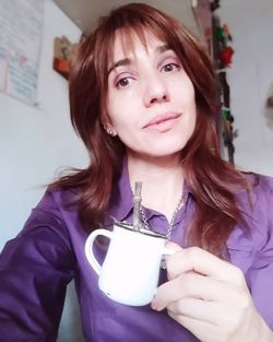 Portrait of beautiful woman drinking water at home